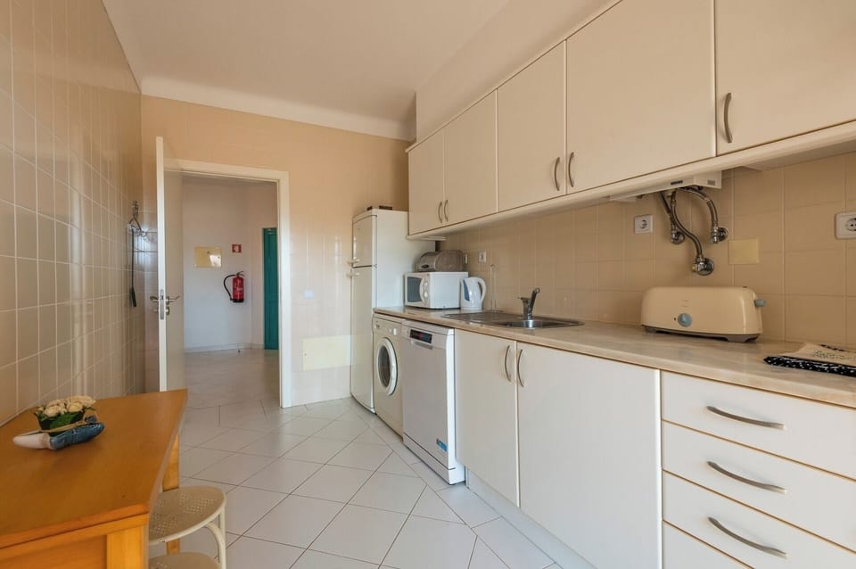 Equipped kitchen with balcony access.