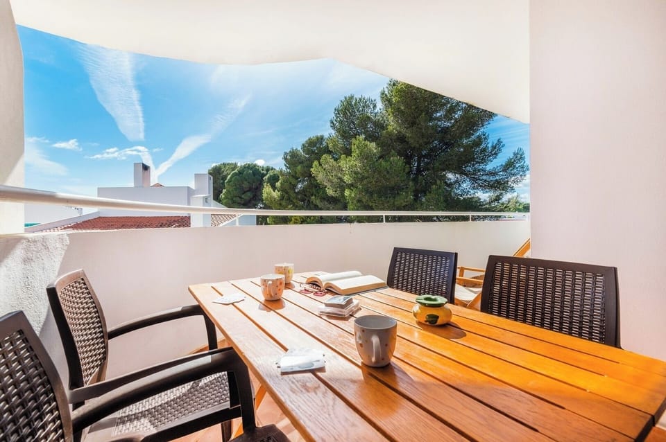 Balcony with dining table and seating area.