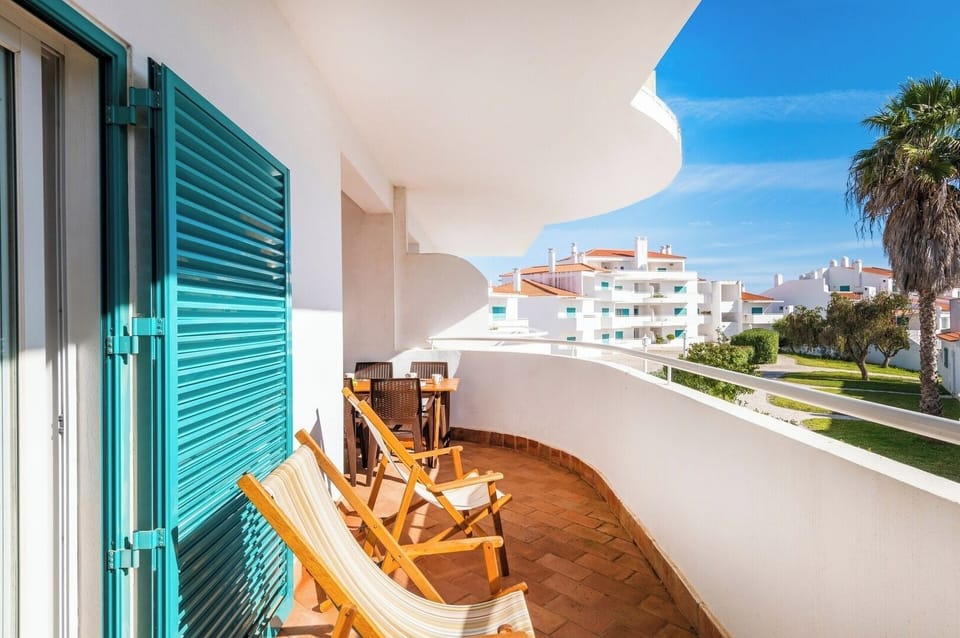 Balcony with dining table and seating area.