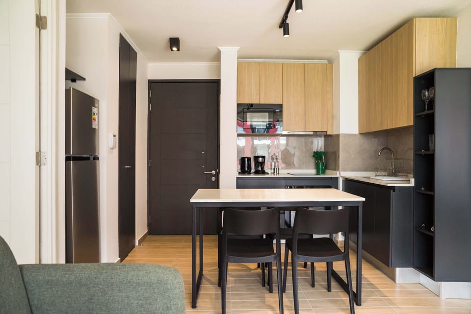 Modern kitchen with sleek design and dining area, perfect for cozy meals.