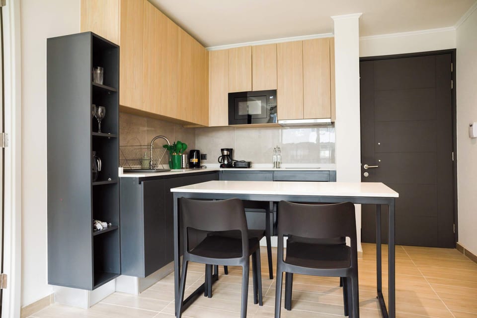 Modern kitchen with sleek design, perfect for cooking and dining in style during your stay.