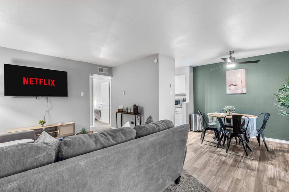 Spacious and inviting living area with comfortable seating and a smart TV, perfect for relaxing after exploring Arlington or attending events at AT&T Stadium.