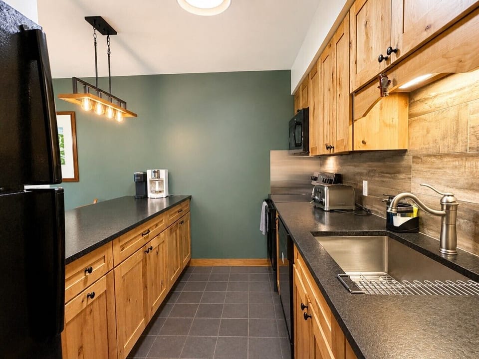 A fully equipped galley kitchen makes first-chair breakfasts and relaxed dinners at home easy.