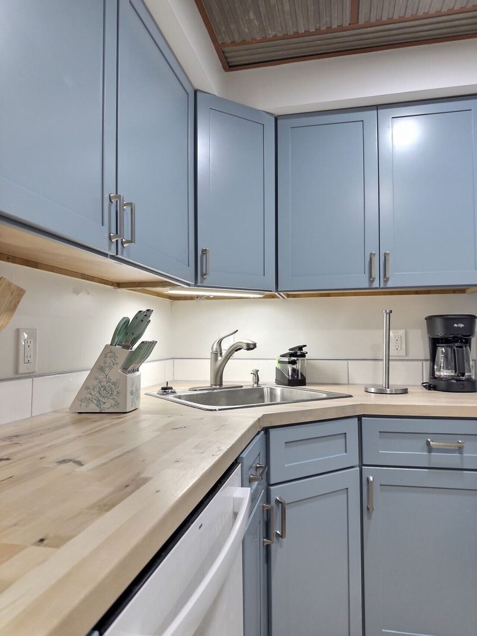 Clean, modern kitchen sink with essential tools.