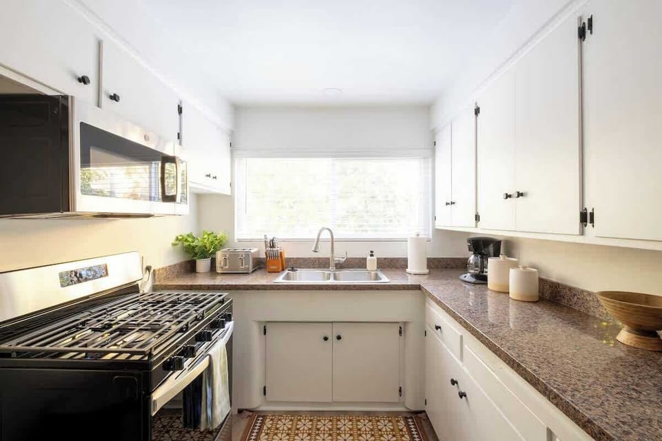 The charming kitchen comes stocked with all the essentials for your stay