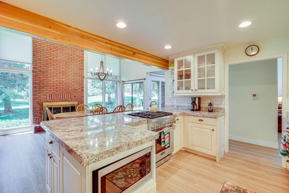 Bright open kitchen and dining area with granite island 