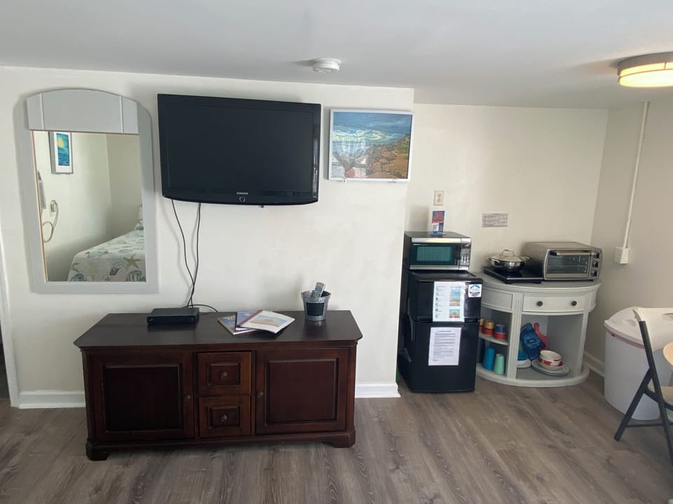 Relax in your private space with modern conveniences—flat-screen TV, microwave, mini-fridge, and coffee essentials all at your fingertips for comfortable stays.