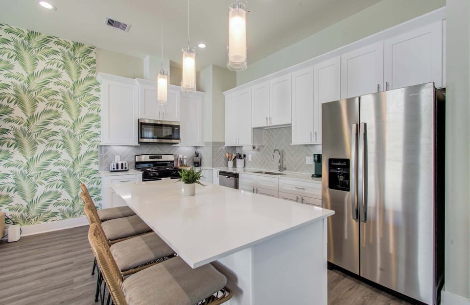 Featuring a sleek, modern design, this fully equipped kitchen has everything you need to whip up a tasty meal, including a breakfast bar & stainless steel appliances.