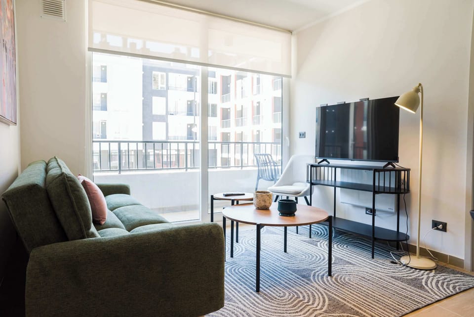Bright and modern living room with balcony access, perfect for relaxation and entertainment.