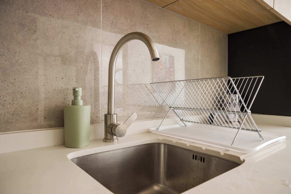 Modern kitchen sink with stylish fixtures and ample counter space for your culinary needs.