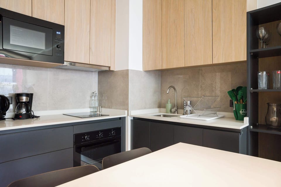 Sleek and modern kitchen with all essentials for your culinary needs, perfect for cooking and enjoying meals.