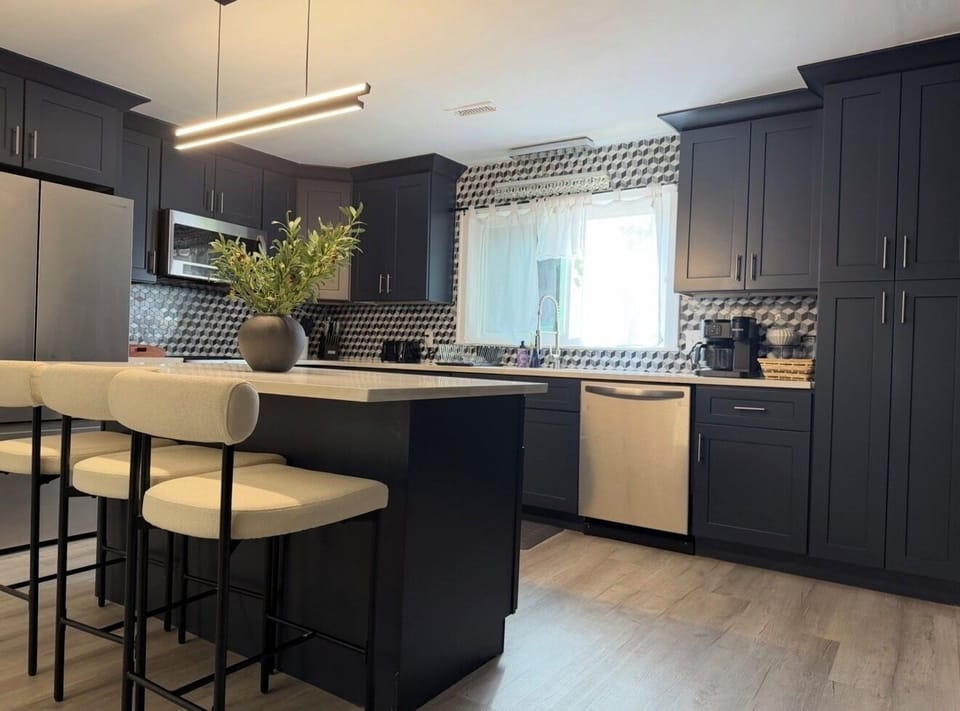 Beautiful modern kitchen with oversized island and seating for 3