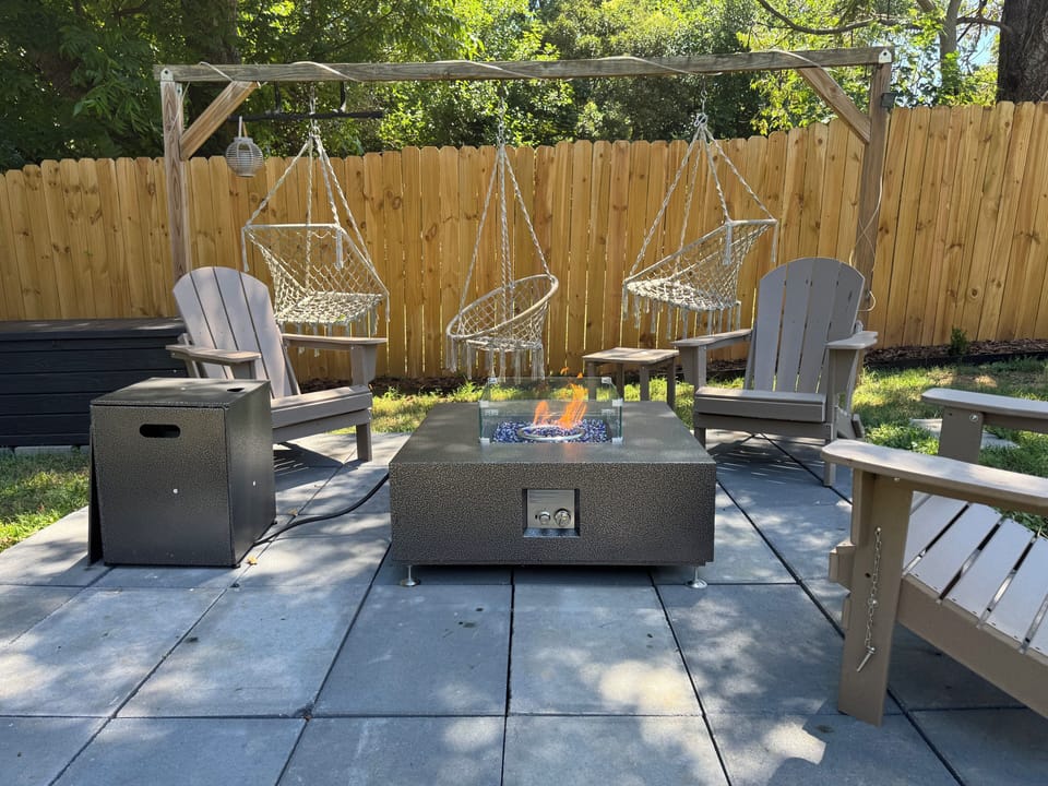 Gather around the fire pit with Adirondack seating and relaxing hanging chairs.