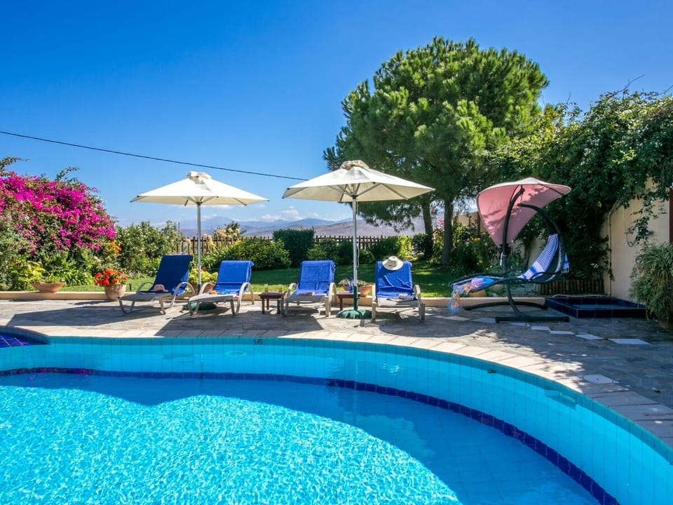 Private pool with comfortable sun loungers and umbrellas