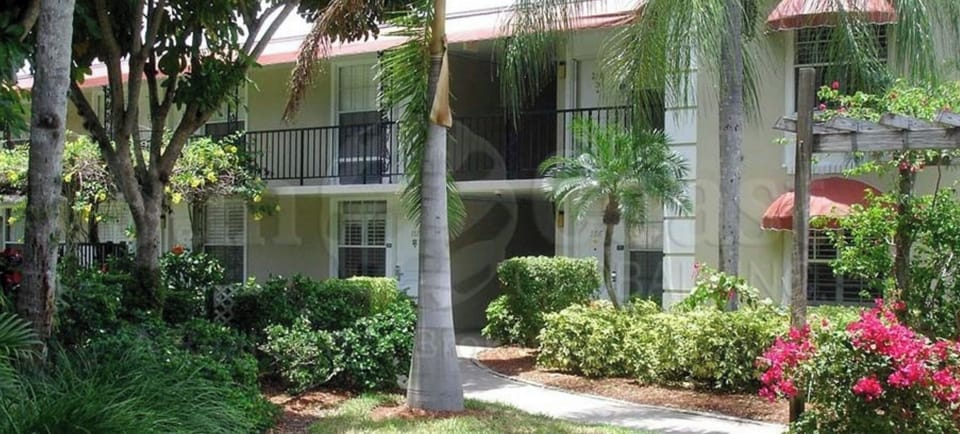 Parking lot view. Enter at pergola on Rt. Unit is by the small palm tree.
