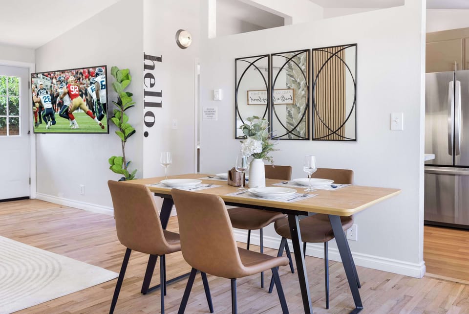 Your dining area effortlessly transitions from meals to movie nights with the discreetly placed television.