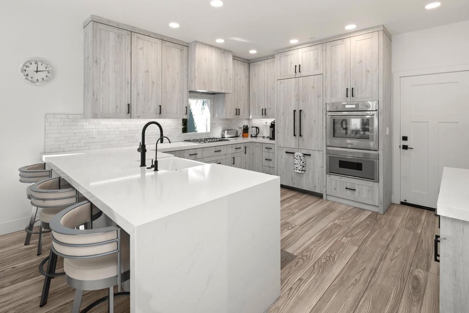 Your modern kitchen keeps everything within reach, with bright counters and seating that naturally becomes a gathering spot.