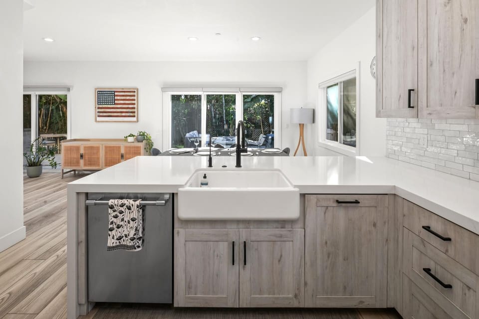 Cook with ease at the oversized island featuring bar seating, generous prep space, and clear views toward the yard.