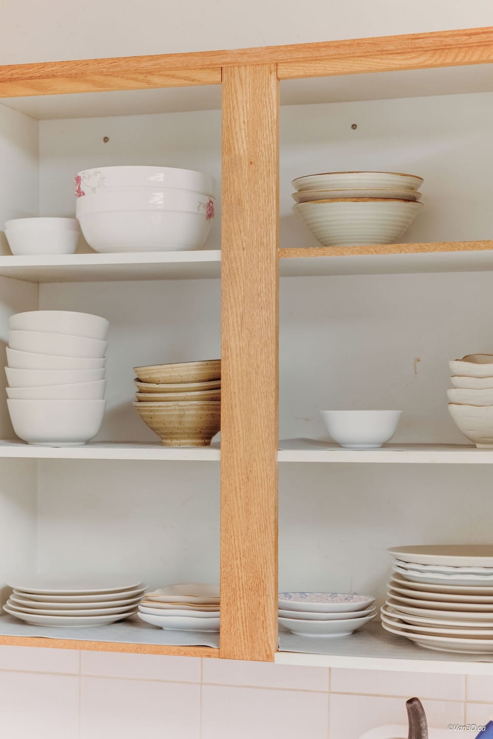 Open shelving with dishes, bowls, and kitchen essentials.