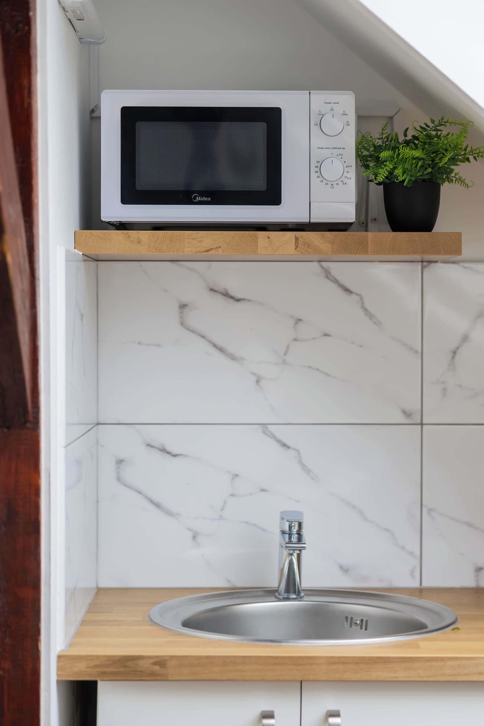 Kitchen detail with microwave and sink.