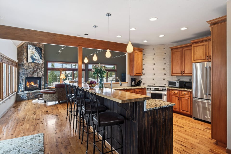 Side view of the kitchen showing the granite countertops and wood cabinetry.