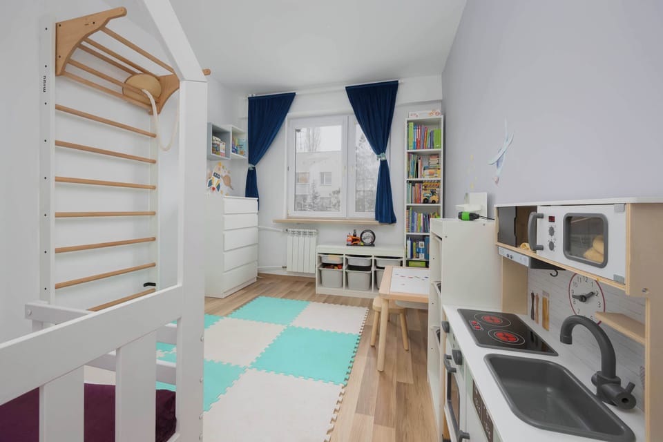 Cheerful children’s room with single bed and playful decorative elements.