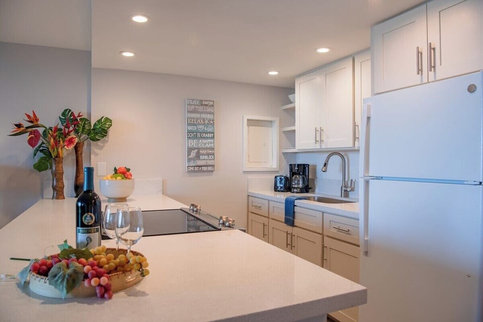 Bright kitchen opens to cozy lounge and breezy lanai—ideal for entertaining or unwinding