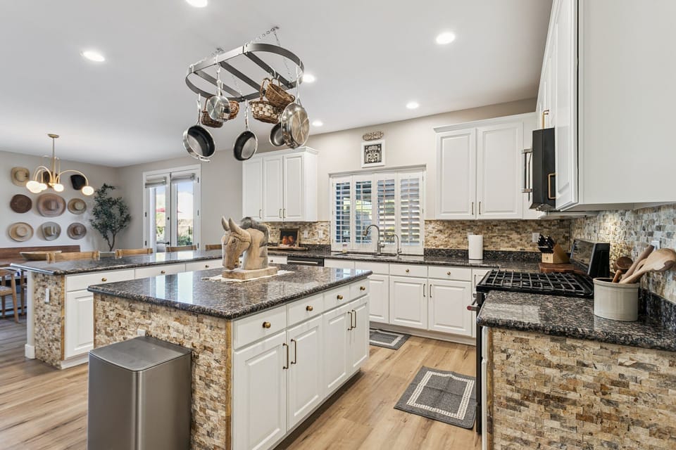 Your gourmet kitchen awaits with granite countertops, stainless steel appliances, and a chef's island perfect for preparing memorable meals together.