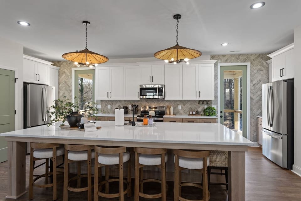 (House 1) Kitchen with TWO full sized refrigerators; washer dryer located in the left cabinet + walk in pantry on the right.