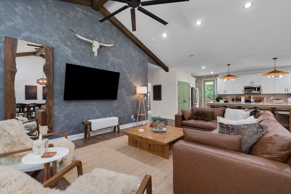 (House 1)The spacious living room, featuring a 72 in TV and plenty of seating
