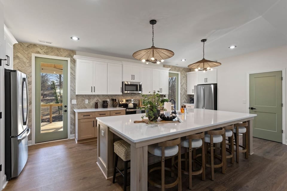 (House 1) Large kitchen with TWO full sized refrigerators, coffee station, island seating for 8, and stocked with enough dishes and cookware to host.