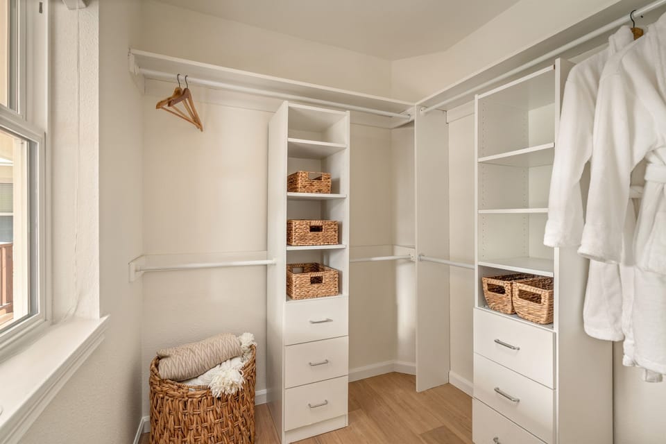 Primary suite walk in closet - perfect for longer stays! Spa robes provided.