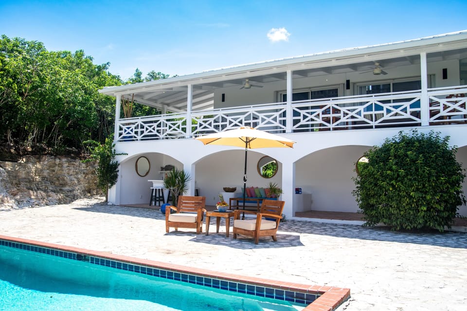 Outdoor pool area with covered bar and lounge area