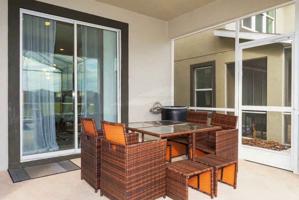 Enjoy the screened patio with outdoor dining, lounge chairs, private pool, relaxing spa, sunny views, and open green surroundings, perfect for peaceful moments by the water.
