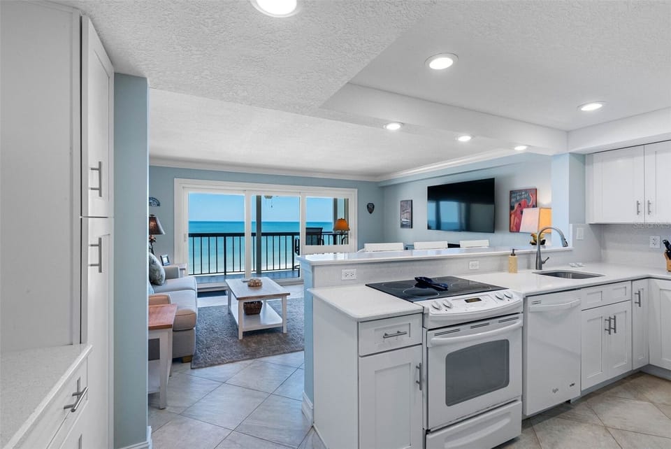 View of the coffee bar to the left, the kitchen and the living room