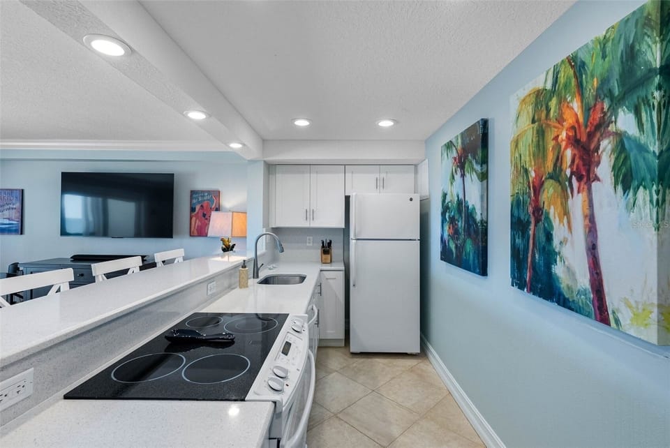 Full-size kitchen and 65-inch HD TV with Sony sound bar and subwoofer
