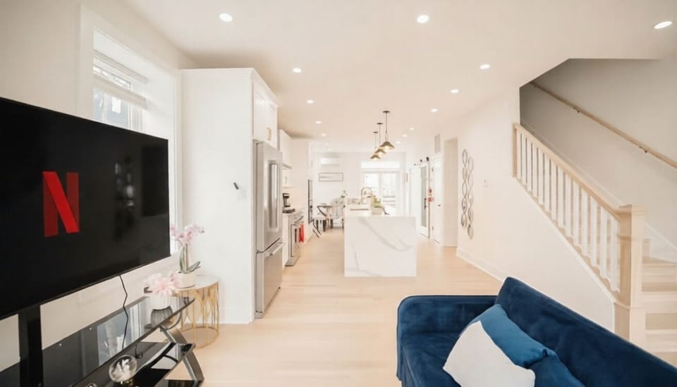 Sleek, sun-drenched open-concept kitchen and elegant living area