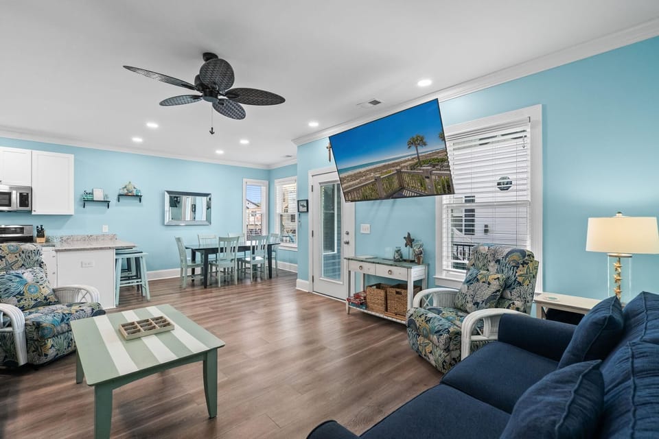 Spacious living room with coastal charm and vibrant blue accents