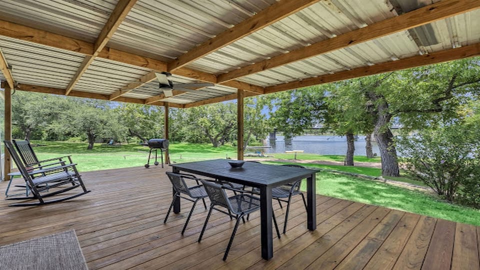 Spacious covered deck for outdoor dining and relaxing river views.