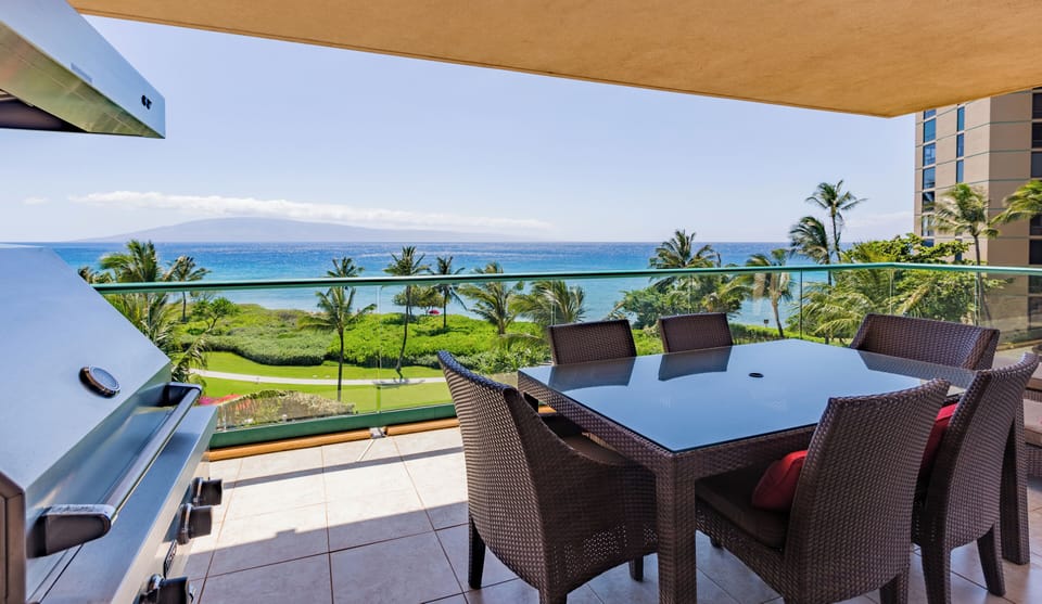 Covered balcony with dining table and panoramic ocean views, perfect for meals in the breeze.


 HKK-450