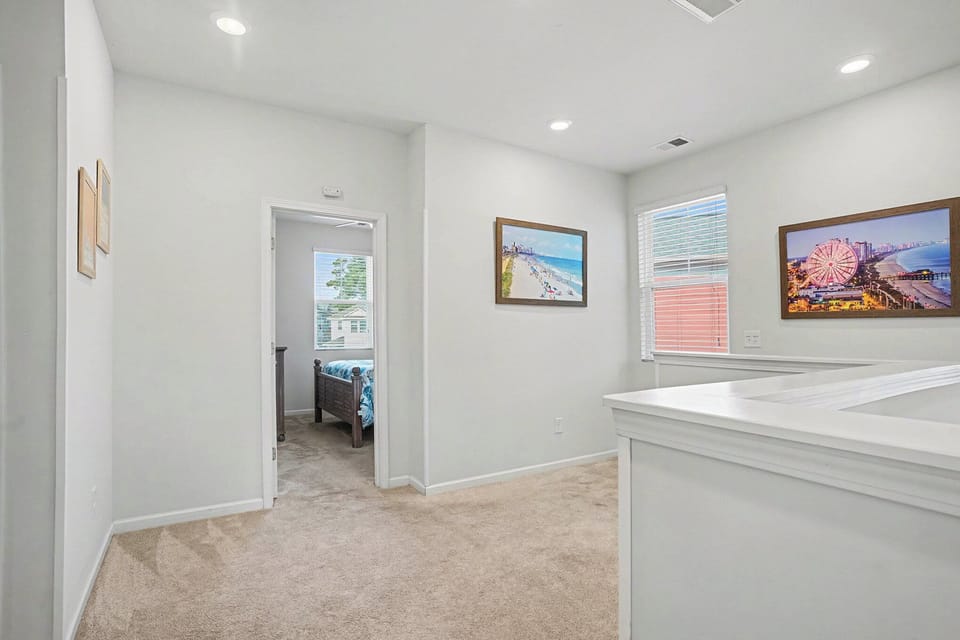 Upstairs hallway offering easy access to bedrooms and shared bathroom.
