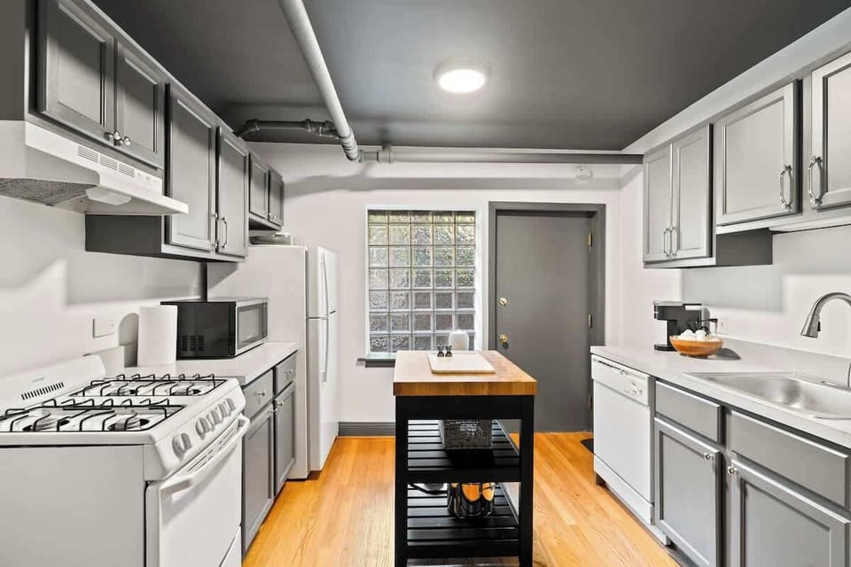 It's not a bad space to cook in.  The center island helps out greatly, even though it is a little bit of a chore to navigate around an open dishwasher.  Plus hiding in a cabinet is my collection of Wonder Woman glassware collected when I was 12.