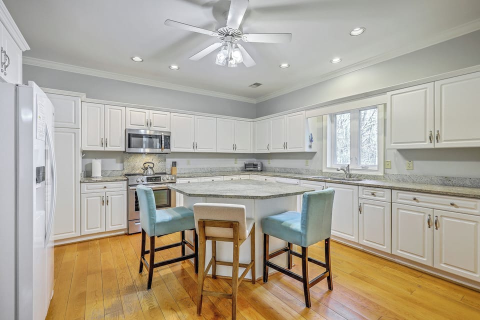 A well-equipped space with modern appliances and a central island—making meal prep a total joy.