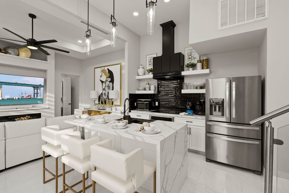 Fully equipped modern kitchen with spacious island seating, ideal for meals, entertaining, and gathering together.