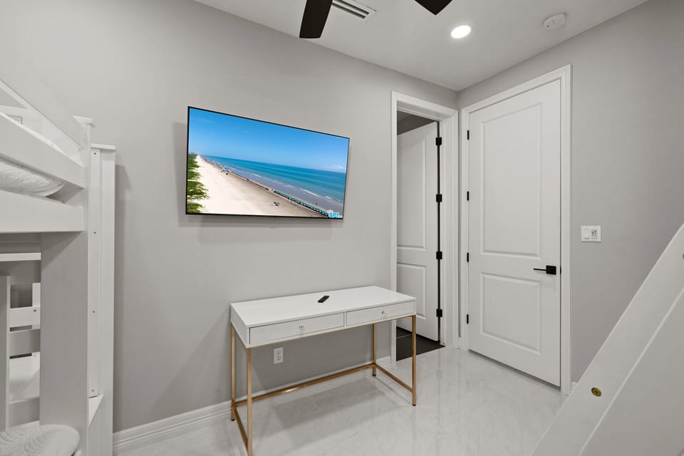 Bunk room with flat screen TV.