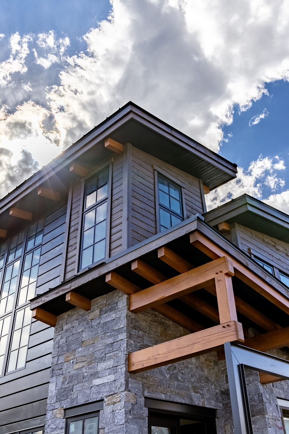 Modern mountain home with timber accents and floor to ceiling windows