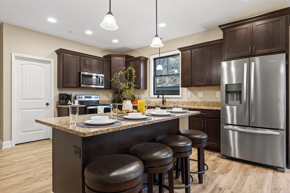 A spacious, fully equipped kitchen with island seating—perfect for group meals and morning coffee.