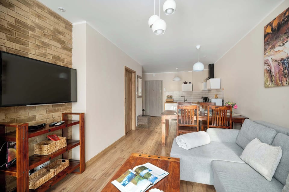 Bright open-plan space combining lounge and dining areas in a warm, welcoming atmosphere.