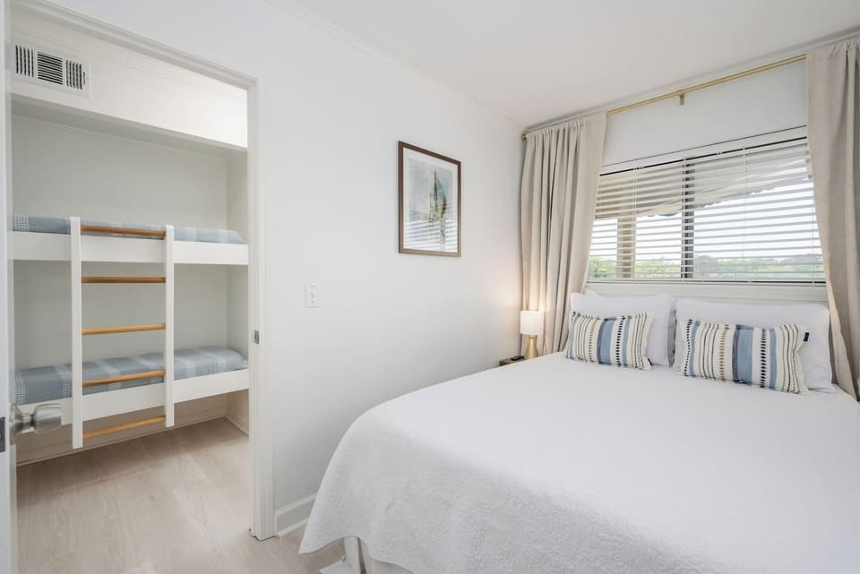 Private bedroom featuring a new ADJUSTABLE queen bed, closet, and nightstands. 