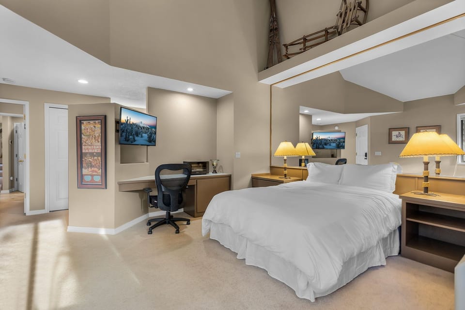 B unit work station. Unwind in your spacious loft-style bedroom with soaring ceilings, crisp linens, and a dedicated workspace for any travel planning.